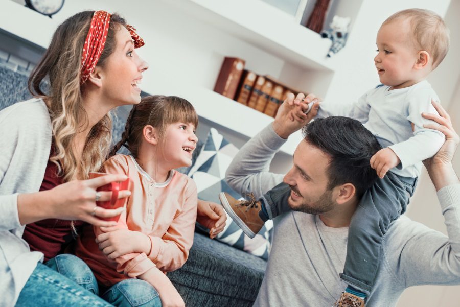 Happy family mother,father and children at home.
