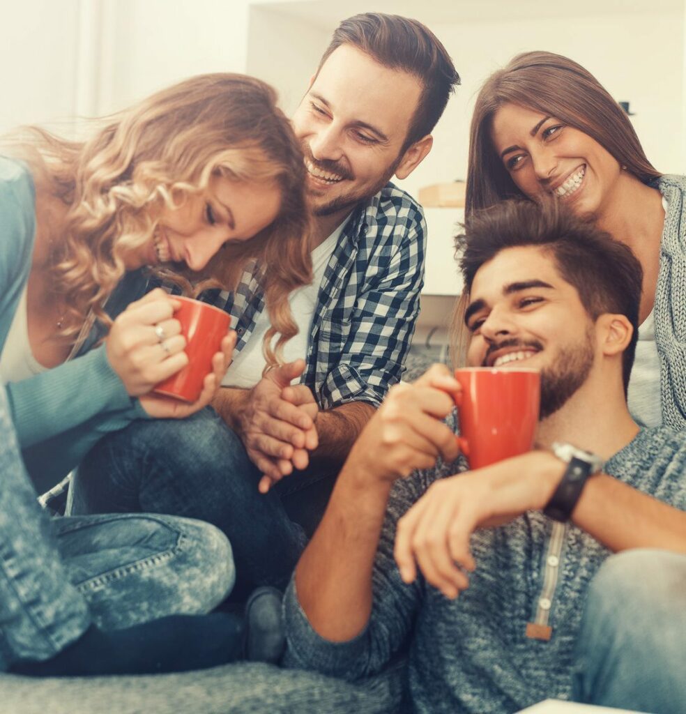 Cheerful group of friends having fun at home