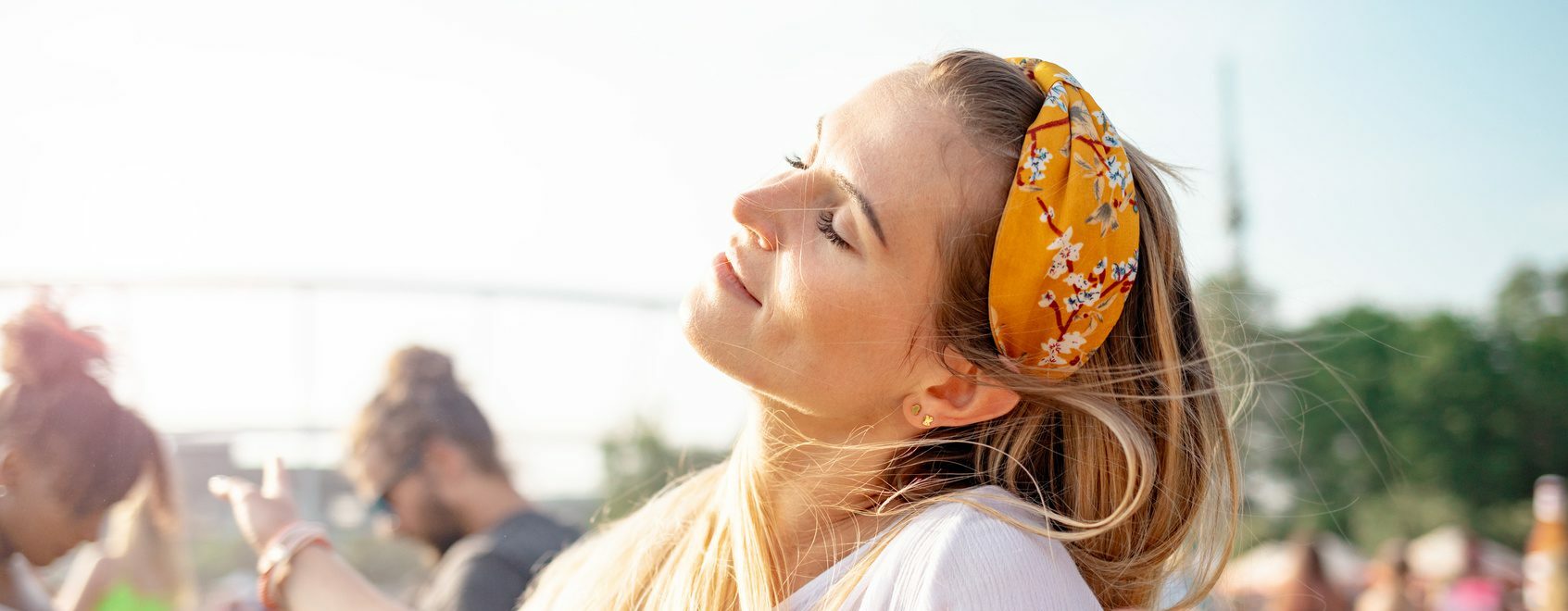 Group of friends having fun at summer music festival